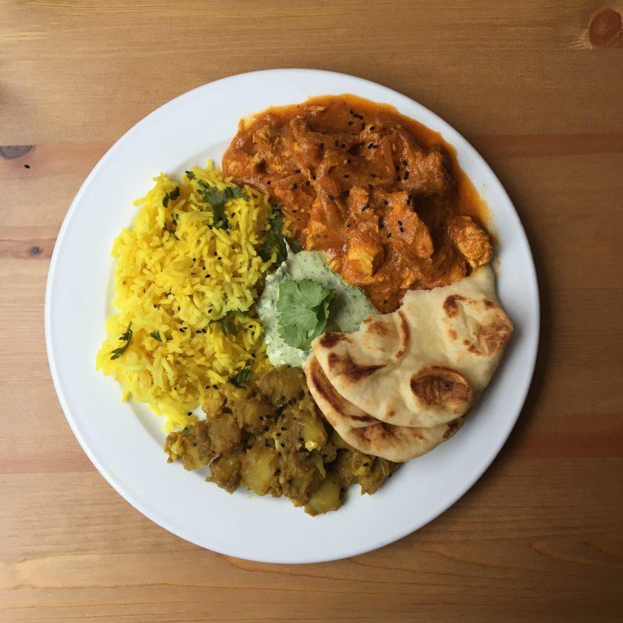 Aloo Gobi, Chicken Tikka Masala, chutney and rice on a plate. (Photo by Andrew Ankersen)