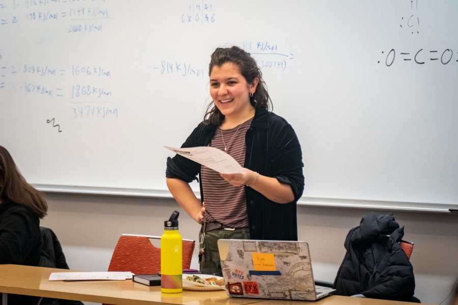 Kat Facchini talks to her colleagues during an NYDM meeting. On Facchini’s laptop are stickers from NYU Welcome Week and NYDM. (Photo by Tony Wu)