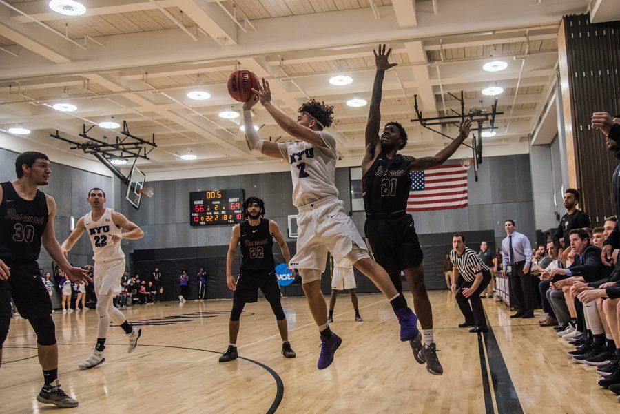 Junior Cameron Moore attempts a 3-pointer as time expires in a 69-66 loss to Rosemont College on Nov. 27. (Photo by Sam Klein)