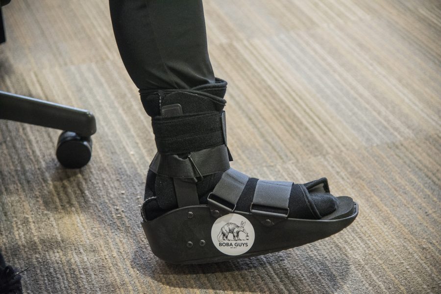 After injuring his foot tap dancing in his room, Mark Yokoyama put a Boba Guys sticker on his walking boot. (Photo by Sam Klein)
