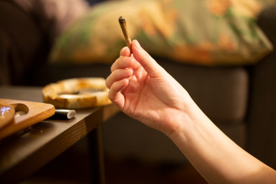 A woman holds a joint in a Brooklyn apartment. Cannabis use is on the rise among people ages 65 and over. (Staff Photo by Alina Patrick).