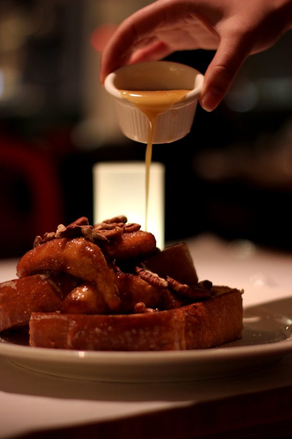 Brioche+french+toast%2C+caramelized+with+bananas+and+walnuts+drizzled+with+a+side+of+maple+syrup.+%28Photo+by+Carol+Lee%29