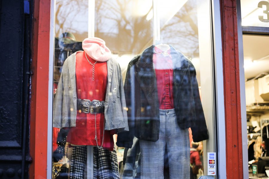 Outfits in the window of Buffalo Exchange, a thrift and vintage store located on 11th Street. (Staff Photo by Julia McNeill)