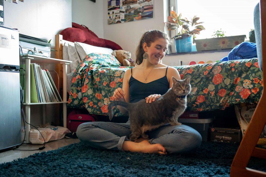 Tisch sophomore Megan Jeter sits with her emotional support animal Phoebe on the floor of her room in Alumni Residence Hall.(Photo by Katie Peurrung)