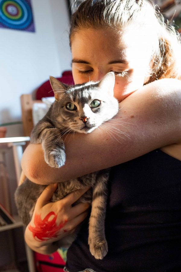 Jeter kisses her emotional support cat, Phoebe, who lives with her in Alumni Residence Hall. Jeter was inspired by her previous roommate who had an emotional support animal. (Photo by Katie Peurrung)