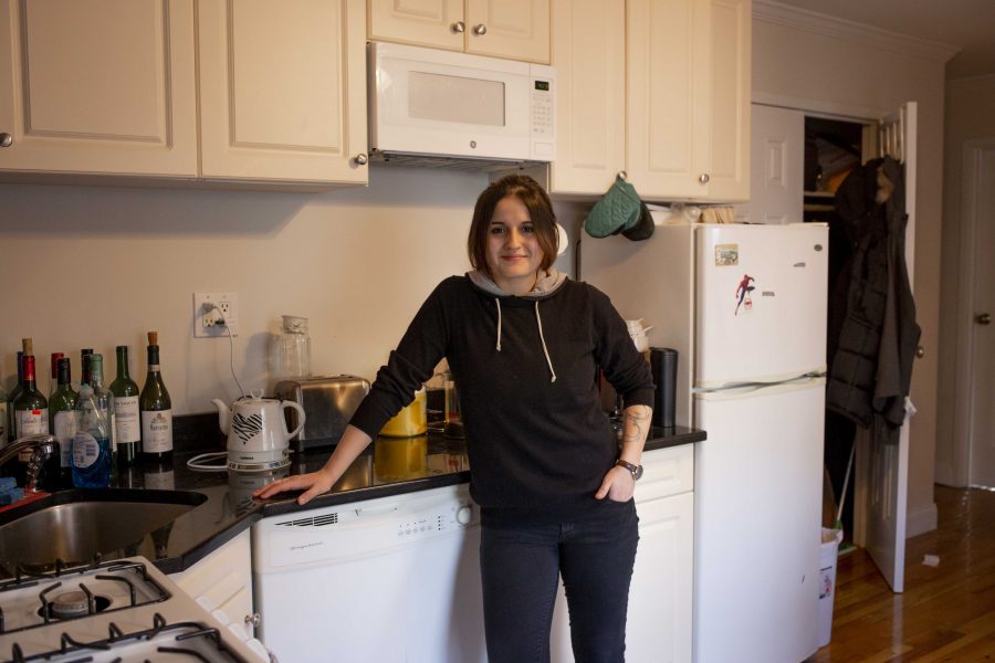 Izzy Stein stands in front of her kitchen counter in her apartment on St. Marks Place. Stein moved off-campus last semester. (Photo by Katie Peurrung)