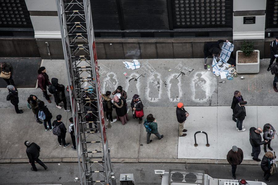 Chalk outlines on Washington Place memorialized the 108th anniversary of the Traingle Shirtwaist Factory fire on Monday. The fire was one of the deadliest industrial disasters in U.S. history. (Photo by Sam Klein)