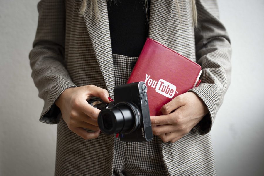 Steinhardt sophomore Ainura Kudaibergen holds her vlog camera and a YouTube-branded notebook, which she fills with video ideas. She has been posting to YouTube since 2012. (Photo by Katie Peurrung)