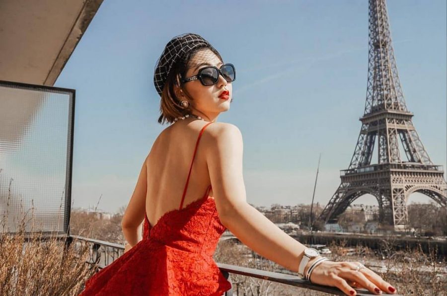 Candice Wu, a Stern graduate student, dons a stunning red dress, a splash of color amidst the rustic Paris background. (via Instagram)