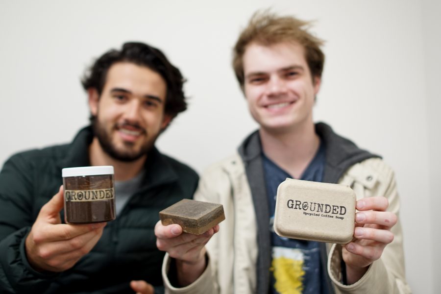 Gallatin senior Parker Reposa (left) and Stern junior Drew Enyedi (right,) founders of the up-cycling company Grounded, display their handmade face mask and soap. All of their products are made from recycled coffee grounds. (Staff photo by Min Ji Kim)