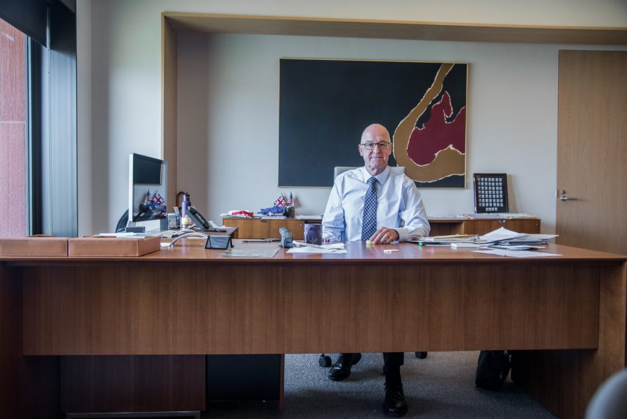 NYU President Andrew Hamilton at his desk in his Bobst office. (Photo by Sam Klein)