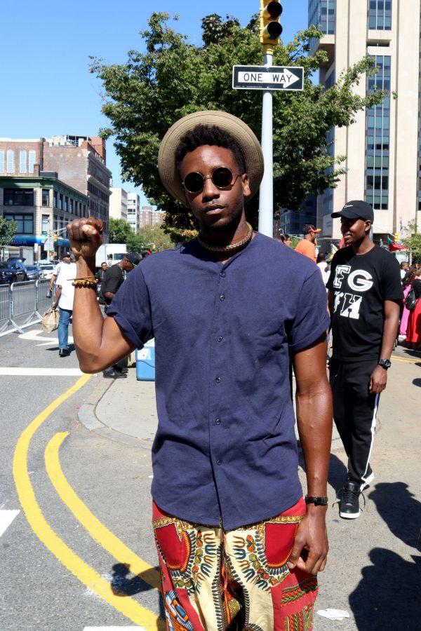 A participant holds up his fist, a sign that often is meant to convey solidarity with oppressed peoples.