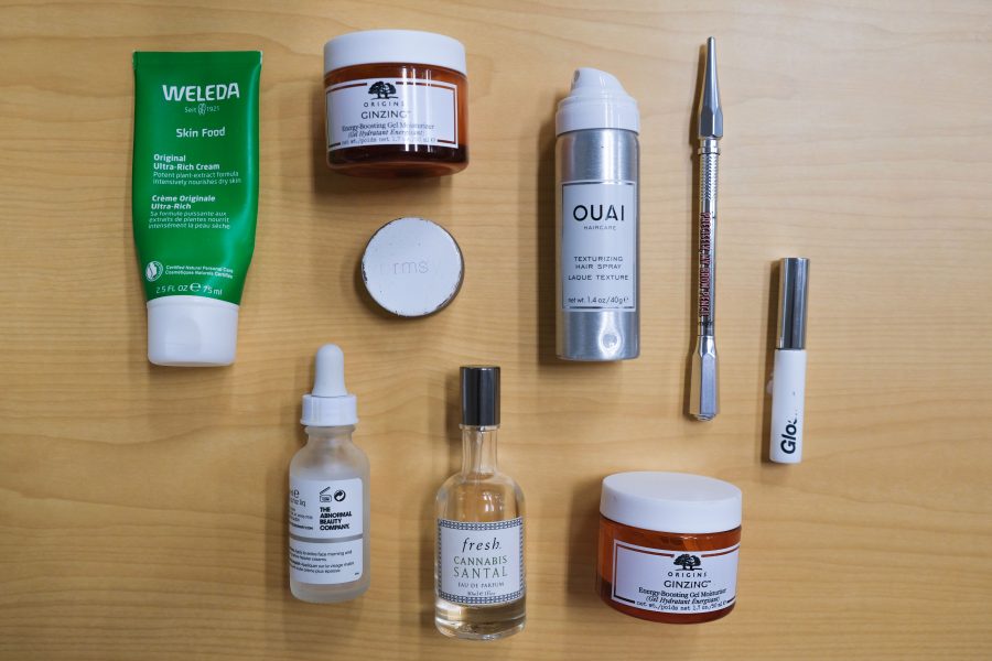 From Origins to Glossier, a myriad of used-up skincare and makeup items are scattered across a table. Our staff delves into which empties they loved, and others they wouldn’t use again. (Staff Photo by Elaine Chen)