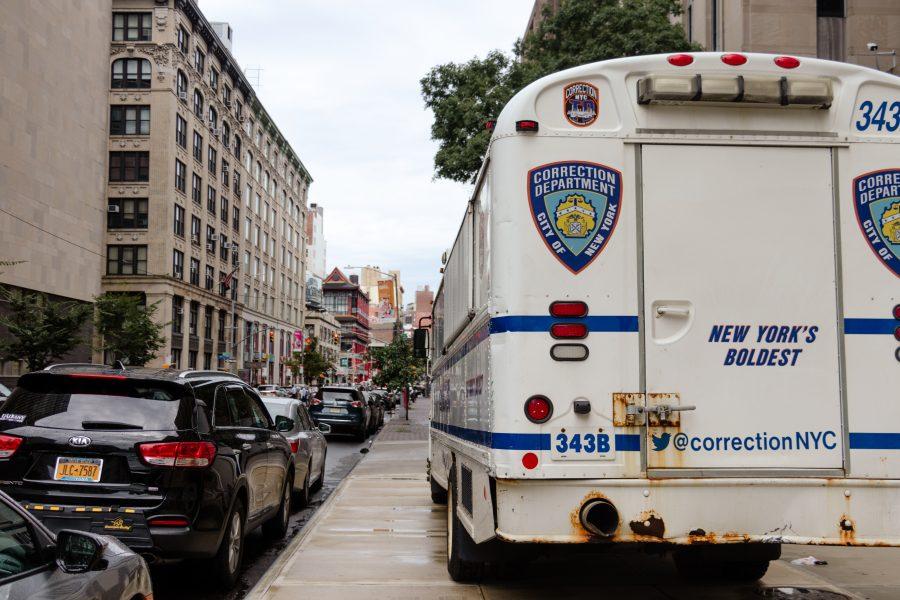 A truck bearing the Correction Department of New York logo is parked near iconic Chinatown buildings. (Staff Photo by Marva Shi)