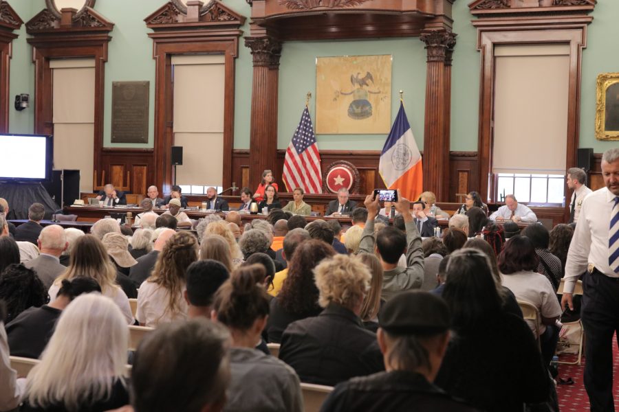 Inside the hearing at City Hall, many gathered for the public hearing on the Rikers Island Closure Plan. (Photo by Sam Clegg)