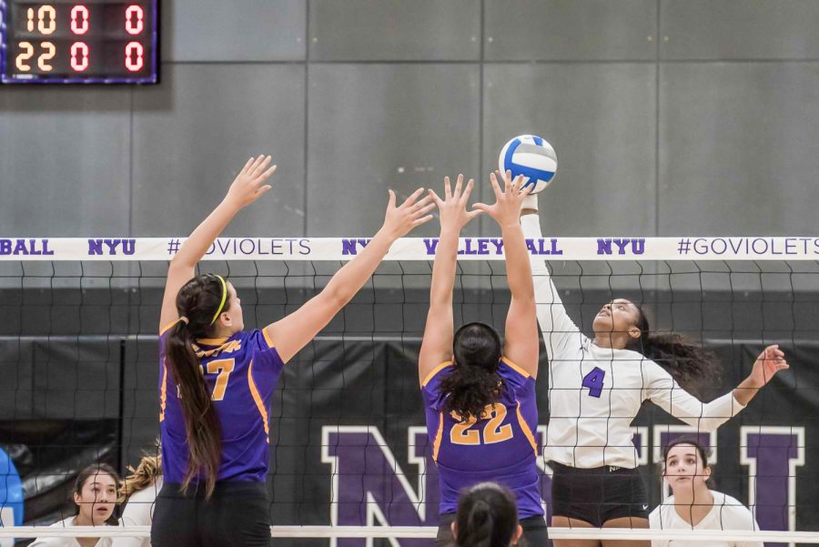 Nazzarine Waldon of NYU Women’s Volleyball spikes the ball against Hunter College. (Staff Photo by Sam Klein)