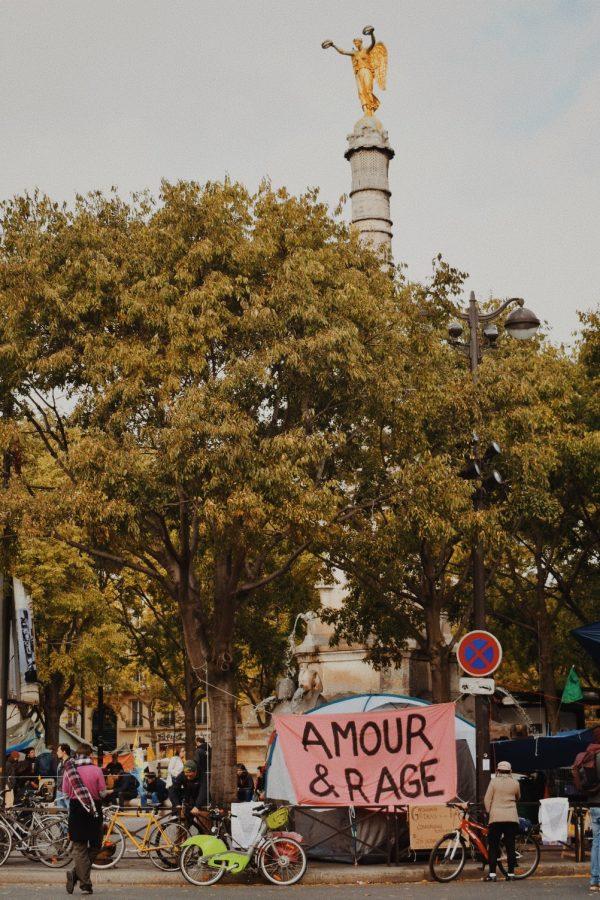 A pink “Amour & Rage” banner still hangs while the weeklong protest begins to be cleaned up.