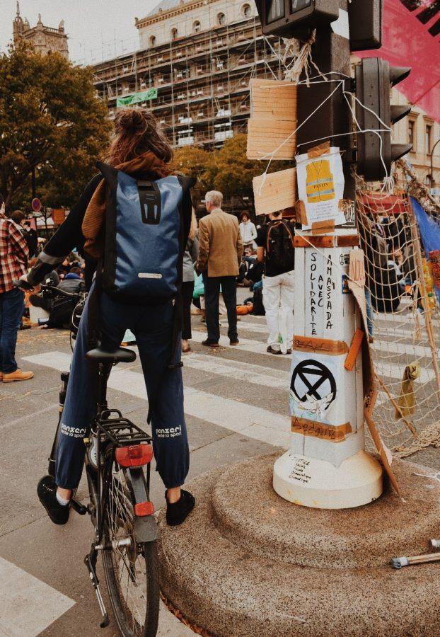 A protester pauses on their bike to listen to speeches by protest leaders on the last day.