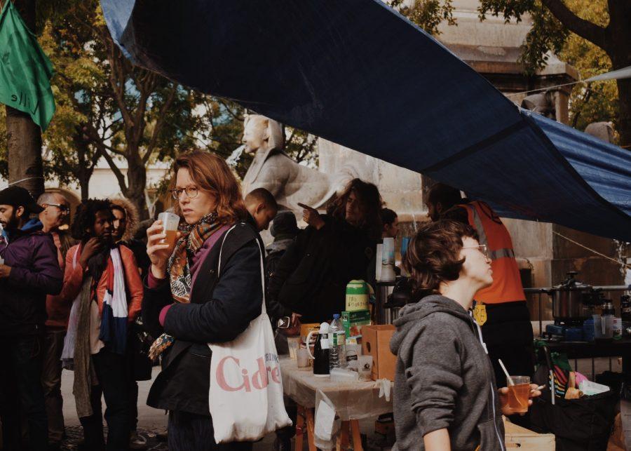 Protesters wait in line for food provided by volunteers.