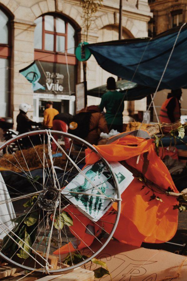 The remnants of art pieces sit while protesters dismantle their work.