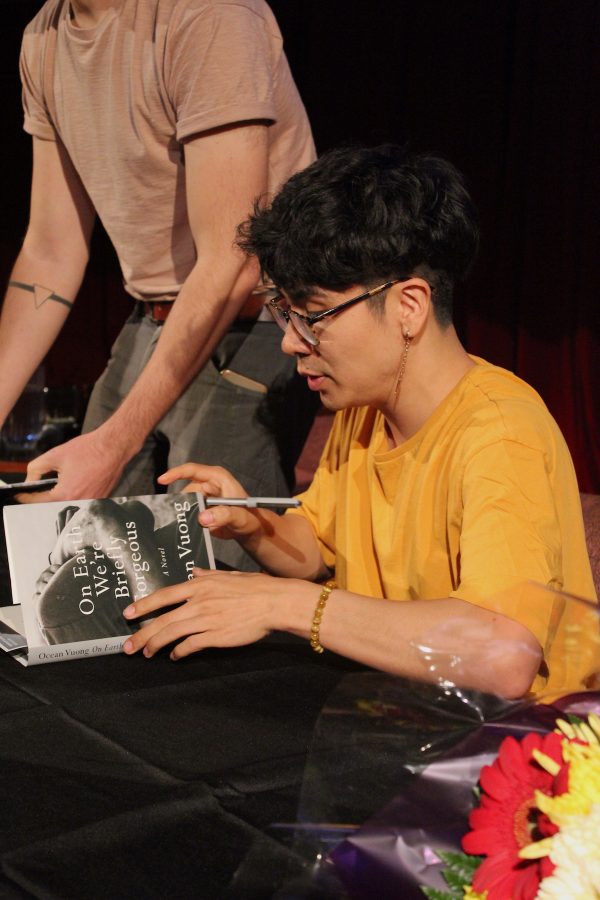 Ocean Vuong opens the pages of his book On Earth We’re Briefly Gorgeous to sign his autograph. On Tuesday, the Asian/Pacific/American Institute at NYU welcomed the award-winning writer and poet as its 2019-20 Artist-in-Residence. (Staff Photo by Emma Li)
