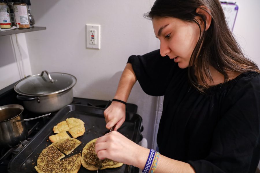 Maha serves her mother’s homemade bread sprinkled with za’atar, a common Middle Eastern spice mixture. (Photo by Elaine Chen)