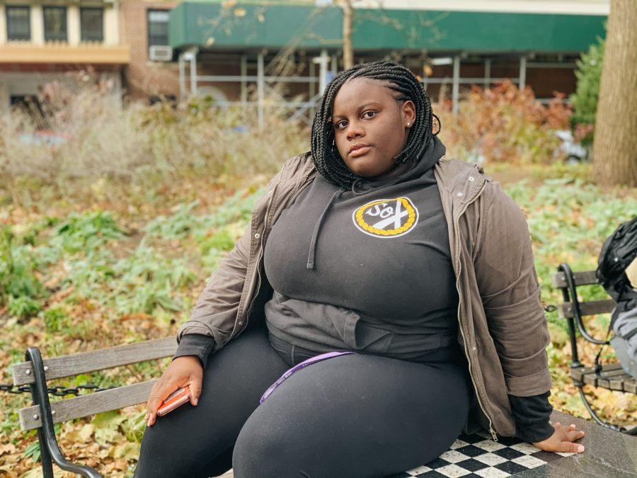 First-year Kim DePass, bundled up on a cold day, enjoys the final days of fall in Washington Square Park on Saturday. “In any aspect of academics, I want to continue to learn history about my identity,” DePass said. (Photo by Mandie Montes)