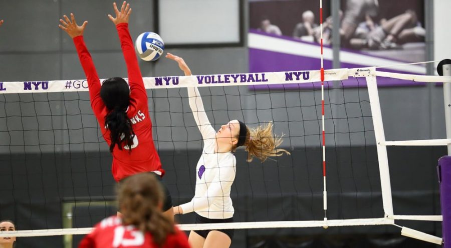 Stern freshman Haley Holz spikes the ball over the net during a match against SUNY Cortland. (Via NYU Athletics)