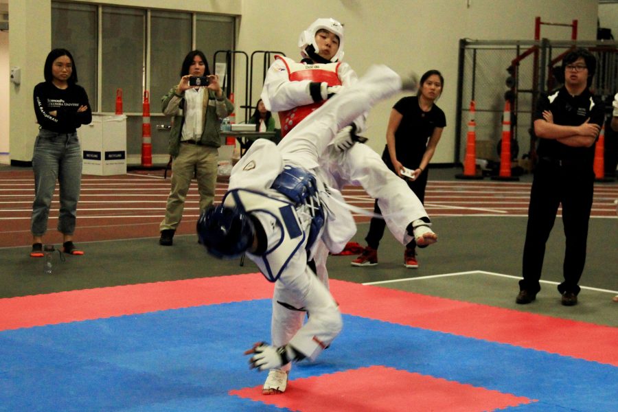 George Chen spars against an opponent. Chen performed Koryeo at the second level of competition for black belt poomsae, winning bronze. (Photo by Alexandra Chan)