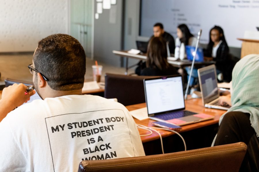 A fellow SGA member wears a “My Student Body President is a Black Woman” T-shirt at the Student Senators Council meeting in support of Jaliyah. (Photo by Marva Shi)