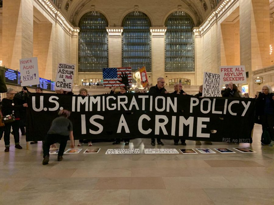 ICE protesters show off homemade banners in Grand Central demonstration.  (Staff photo by Mina Mohammadi)