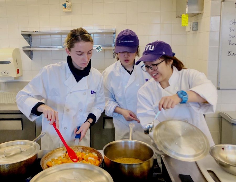 Instructors in the Food Lab help a student with the recipe she must complete in class. The Steinhardt class is a hands-on course that exposes students to a variety of culinary techniques. (Photo by Madison San Miguel)