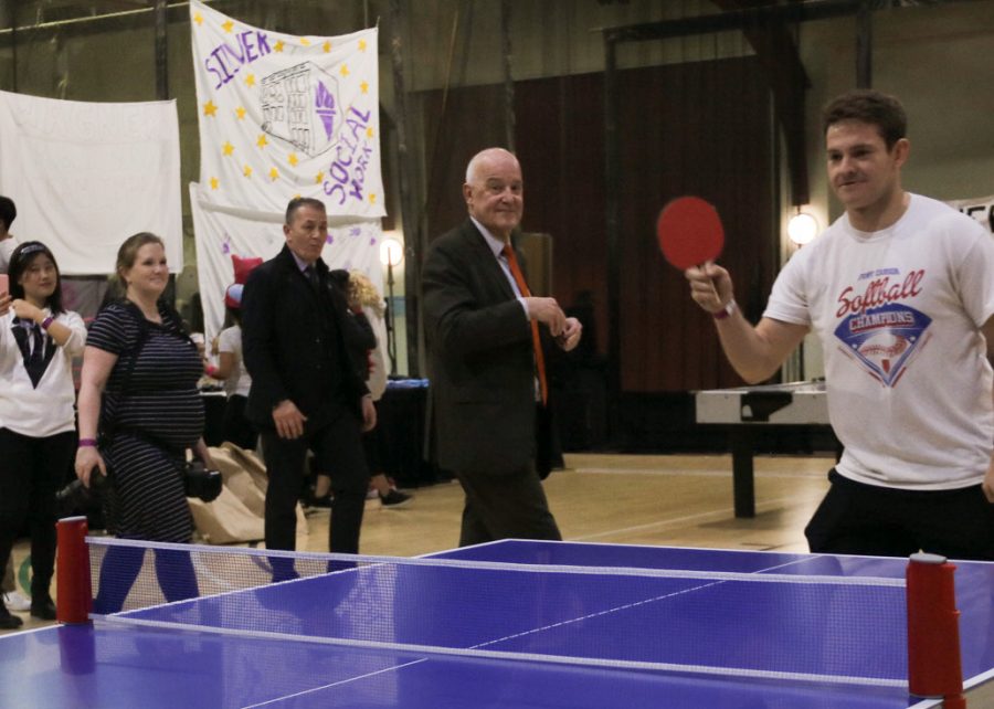 NYU President Andrew Hamilton stops to view a particularly intense table tennis game. Representatives from each NYU school participated in various sports at the All-University Games. (Staff Photo by Alex Tran)