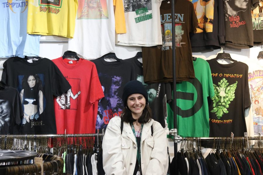 Liberal Studies sophomore Jenn Roberts poses in front of a rack of vintage clothing. Since starting her own Instagram reselling vintage pieces, she has gained nearly 4,000 followers and the attention of popular YouTubers such as Ashley (aka bestdressed). (Photo by Kylie Smith)