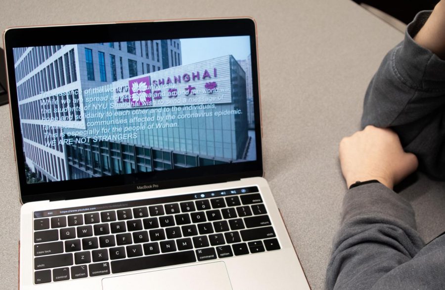 A student watches We Are Not Strangers, a video created by NYU Shanghai students and alumni in solidarity for Wuhan coronavirus victims. The virtual choir rendition of the song encourages unity and hope among staff and students. (Staff Photo by Alexandra Chan)