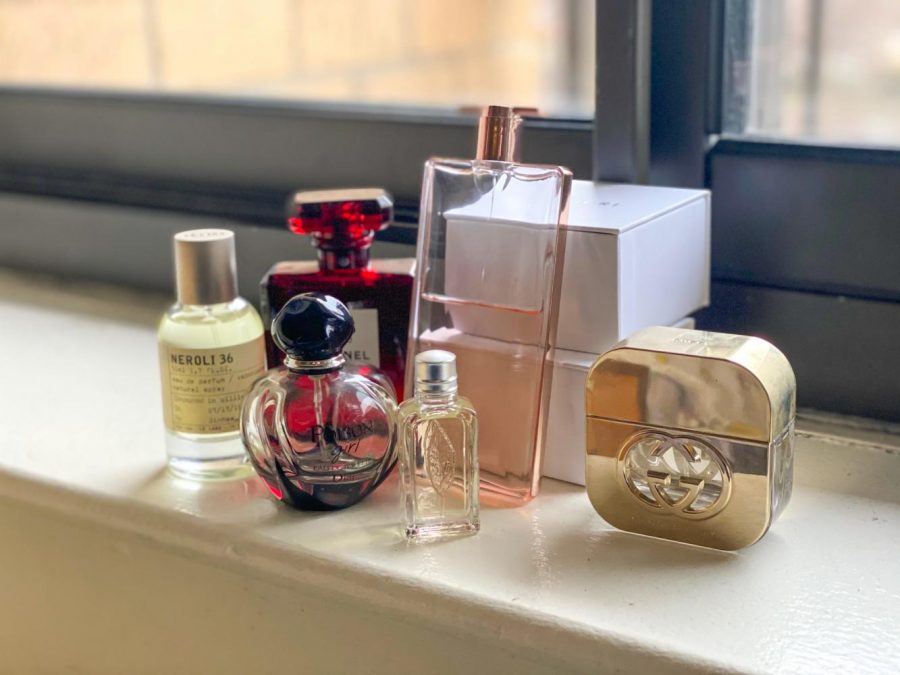 Multi colored perfume bottles line a windowsill. The WSN Culture desk is here to discuss some of their favorite perfumes. (Staff Photo by Bella Gil)