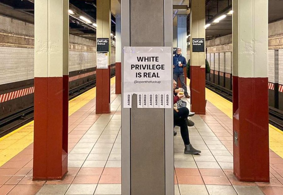 A flyer bearing the statement, “White Privilege is Real” is tacked on a pole in the subway. These flyers have been put up all over the city by Open the F-ck Up, a new social experiment encouraging people to open up about taboo issues. (Image via Instagram @openthefup)