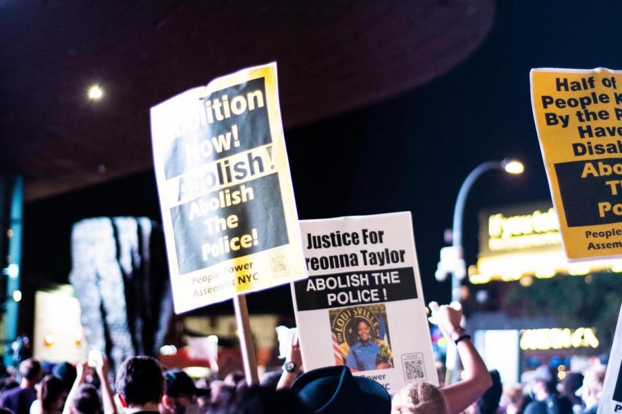 Protesters hold up signs calling for justice for Breonna Taylor and to abolish the police. Many across the country are calling to abolish the crime and punishment system currently in place. (Staff Photo by Jake Capriotti)