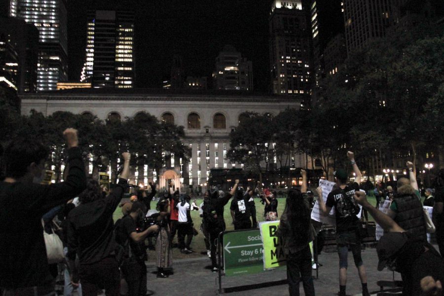 Protesters stop at Bryant Park and raise their fists in solidarity with Black lives. Organizers read aloud the facts around Daniel Prudes murder. (Staff Photo by Alexandra Chan)
