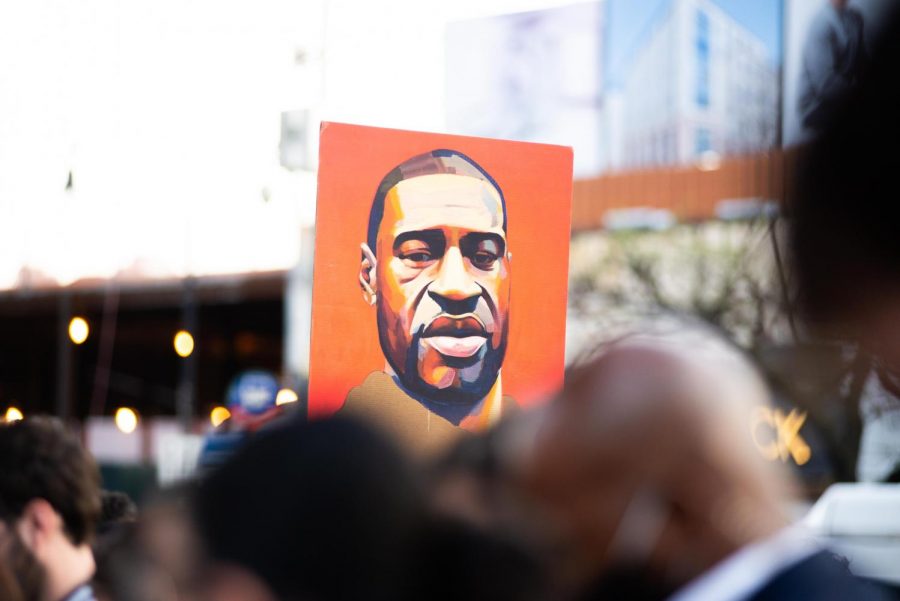 There is a poster with the painting of George Floyd, who was killed in Minneapolis earlier this year. Former Minneapolis police officer Chauvin was convicted for the death of George Floyd. The jury found him guilty of second-degree murder, second-degree manslaughter and third-degree murder. (Staff Photo by Jake Capriotti)