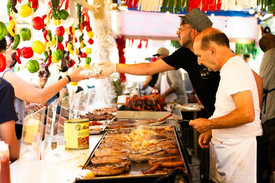 A cook prepares their customer’s food at the Annual Feast of San Gennaro. (Staff Photo by Jake Capriotti)