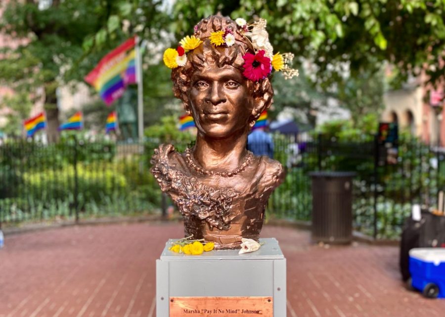 The statue of Marsha P. Johnson, decorated in a wreath and flowers, stands in Christopher Park. This monument honoring the gay liberation pioneer was installed by a local artist without city authorization. (Staff Photo by Sirui Wu)