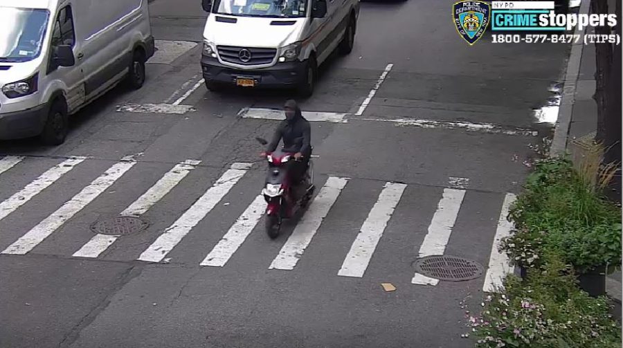 Security camera footage shows the perpetrator wearing a black face mask and riding a red and black moped. The reports all described the attacker wearing dark clothing and a motorcycle helmet covering the majority of their face. (Image courtesy of NYPD)