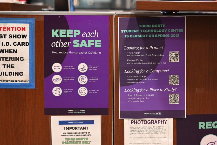 COVID-19 guidelines are taped on the Campus Safety desk at Third North, one of NYU's residence halls. Jp Iregbulem writes that NYU should continue improvements made to public health and accessibility even after the pandemic. (Staff Photo by Sirui Wu)