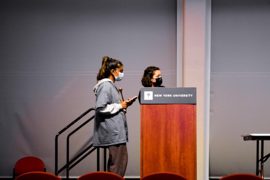 Shreya Tandri (left), a Gallatin student, and Izzy Vieira (right), a CAS senior, spoke at the podium during the NYU Interclub Politics Society Debate on Dec. 1. (Staff Photo by Rachel Cohen)