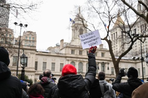 Protesters gathered in front of New York City Hall holding a sign saying "Rescind Homophobic Appointments Now!"