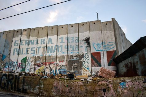 A faded mural covering the concrete Israeli West Bank Barrier compares the bombing of Guernica during the Spanish Civil War with the Nakba, which was the destruction of Palestinian society and displacement of hundreds of thousands of Palestinians after the creation of Israel.
