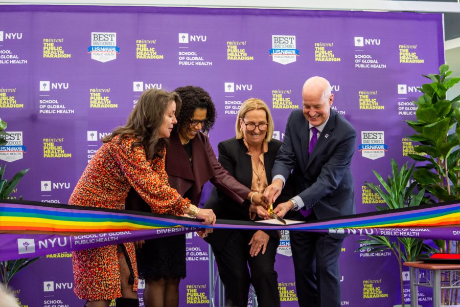 Four individuals collectively cut a rainbow ribbon. From left to right they are: Katherine Fleming, Debra Furr-Holden, Dr. Cheryl Healton and Andrew Hamilton.
