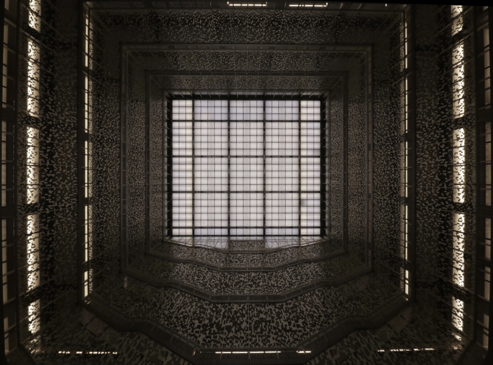 A view looking upward in the Bobst Library atrium. A grid of white light in the ceiling is surrounded by the barriers that enclose the library's levels.