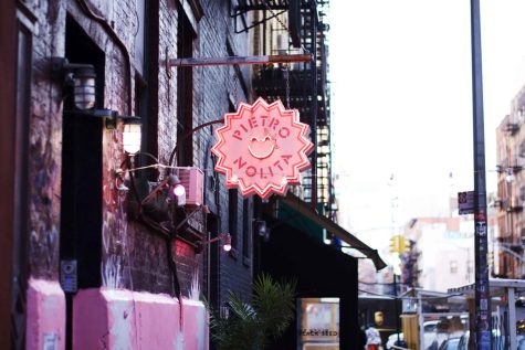 The bubblegum pink sign for Pietro NoLita hangs over the restaurant’s black brick facade.